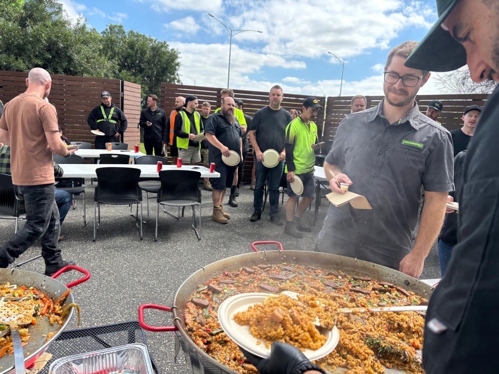 Tapas Madriz chef serving live paella to corporate guests at a Melbourne event